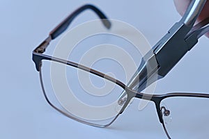 Adjusting nose pads on metal eyeglass frames with chain nose pliers