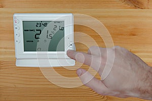 Adjusting the temperature with hand to a wireless thermostat