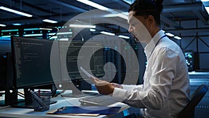 Admin in data center maintaining accurate documentation of infrastructure
