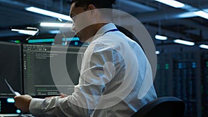 Admin in data center maintaining accurate documentation of infrastructure