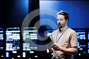 Admin walking in high tech data center
