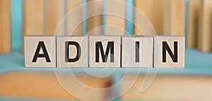 Admin word made from wooden blocks on blue table