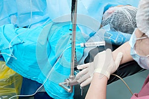 Administering an anesthetic to a patient during surgery.