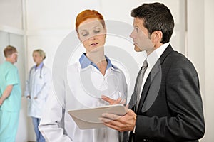 Administrator talking with Doctor at the Hospital