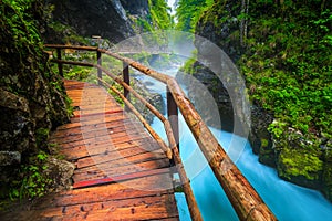 Noisy Radovna river in Vintgar gorge with wooden footbridge, Slovenia