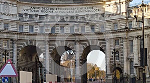 Admiralty arch with three gates leading to palace photo