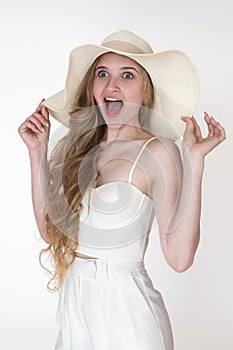 Admiration facial expression of woman stared with mouth open in amazement. Model in floppy straw hat