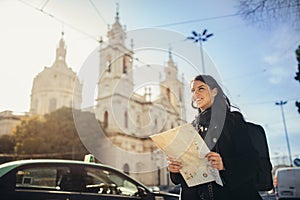 Admiring amazing sunset in european metropola.Traveling in Europe.Female turist in front of Basilica da Estrella