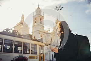 Admiring amazing sunset in european metropola.Traveling in Europe.Female turist in front of Basilica da Estrella photo