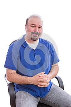 Admiring Bearded Man on a Chair Looking at Camera