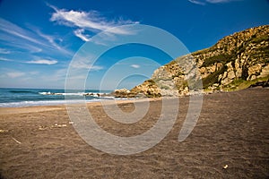 Admiring beautiful scenic sandy beach azkorri in springtime in blue sky