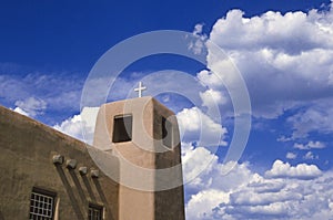 Adobe church and clouds