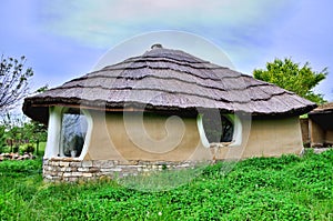 Adobe clay house with thatch photo