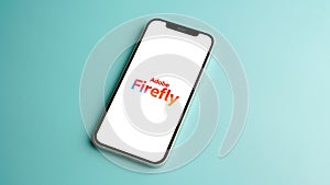 Adobe Firefly logo displayed on mobile phone screen, AI Art generator tool