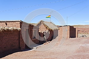 Adobe house in Cerrillos village on Bolivian Altiplano near Eduardo Avaroa Andean Fauna National Reserve with blue sky, Bolivia