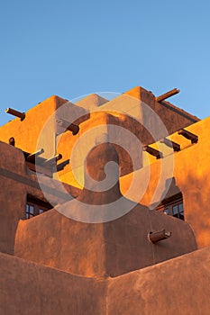 Adobe pueblo-style building glowing in the sunset in Santa Fe, New Mexico