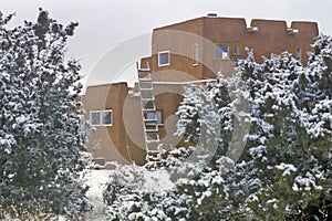 Adobe in snow in Santa Fe, NM photo