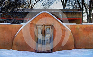 Adobe Wall and Wooden Door in the Snow