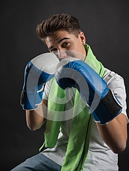 Adolescent boxer with boxing gloves posing