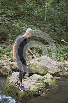 Adolescent boy in nature on the shores of a river