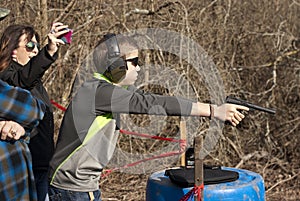 Adolescent Boy with Pistol at the ready