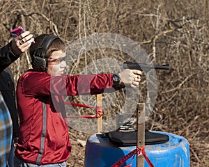 Adolescent Boy Shooting Pistol