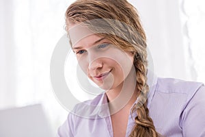 Adolescent female using computer
