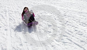 Adolescent girl sledding