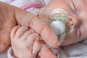 Adoption baby concept. Man is touching baby with hand photo