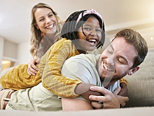 Adoption, love and family play, hug and happy smile, care and laugh together on the sofa in living room. African child