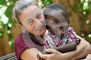 Adoption symbol - Woman adopts a little African boy