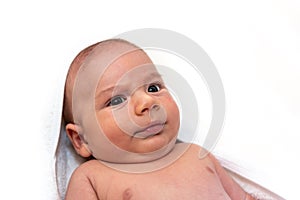 Adorable 2 months old little baby boy on towel after bath over white background