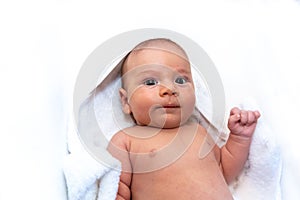 Adorable 2 months old little baby boy on towel after bath over white background