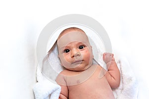 Adorable 2 months old little baby boy on towel after bath over white background