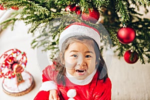 Adorable 3 year old toddler girl enjoying Christmas time