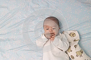 Adorable 4 month old Chinese baby sucking his own finger