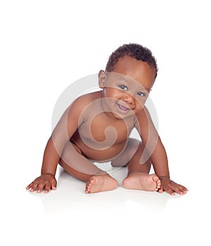 Adorable african baby in diaper sitting on the floor