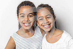 Adorable african twin little girls on studio gray background