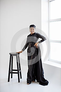 Adorable african woman in elegant wear posing gracefully