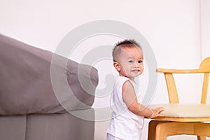 Adorable asian baby boy standing in bedroom,Happy and laughing new born kid