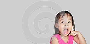 Adorable Asian child thinking isolated on a grey background with space for text