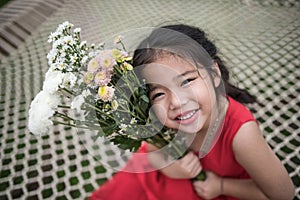 Adorable asian gril kid red gressing with flowers photo