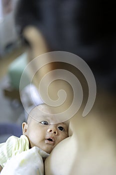 Adorable asian newborn baby boy, Asian mother breastfeeding tenderness and hugging baby with love.