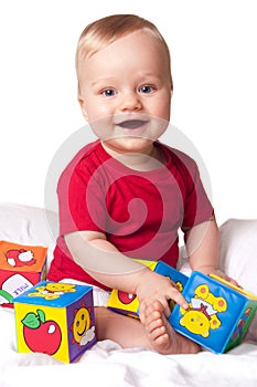 Adorable baby boy with colorful blocks