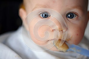 Adorable baby boy having a meal