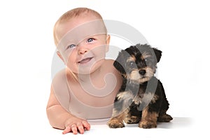 Adorable Baby Boy With His Pet Teacup Yorkie Puppy photo