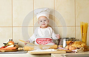 Adorable baby boy in kitchen