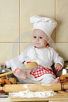 Adorable baby boy in kitchen