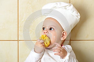 Adorable baby boy in kitchen