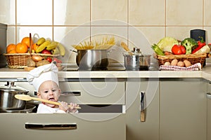 Adorable baby boy in kitchen